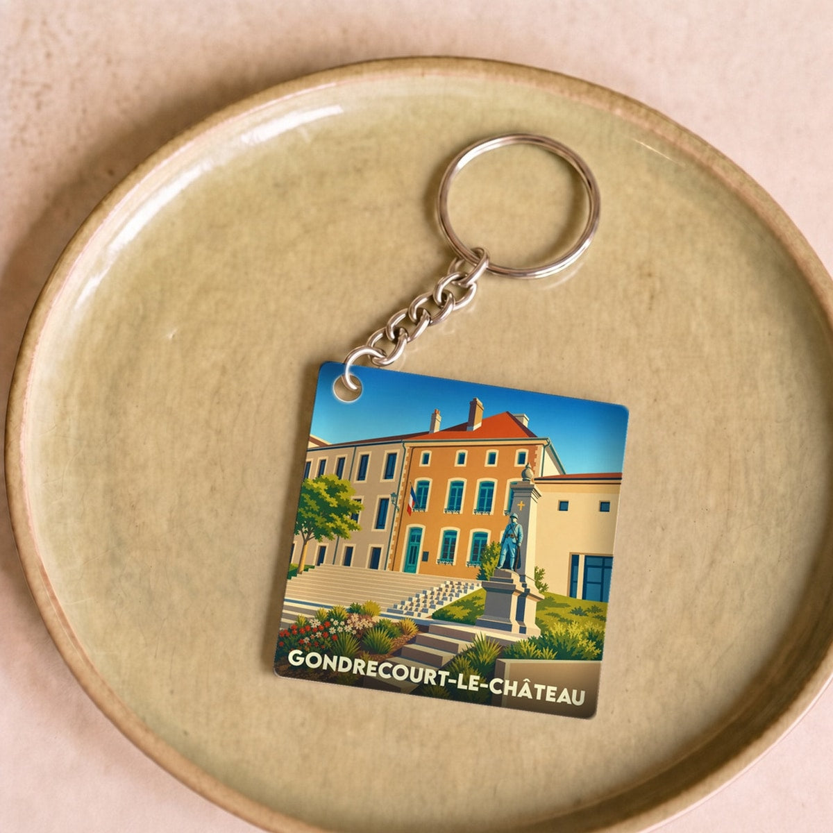 Porte-clés souvenir de la ville de Gondrecourt-le-Château avec une illustration stylisée.