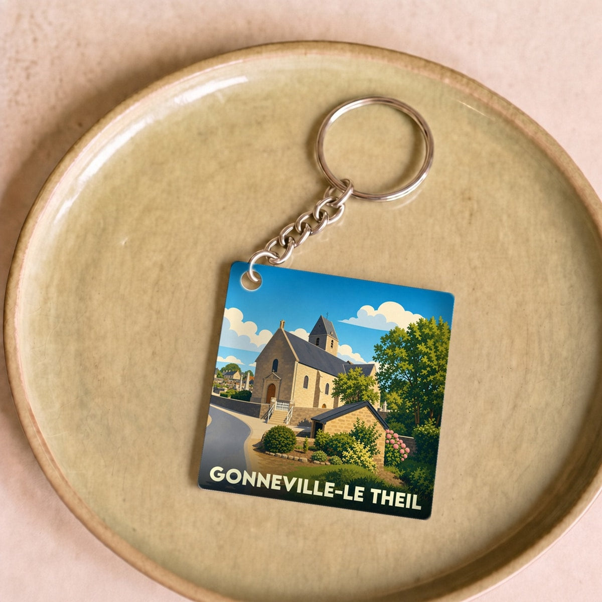 Porte-clés souvenir de Gonneville-Le Theil avec une illustration stylisée de son église.