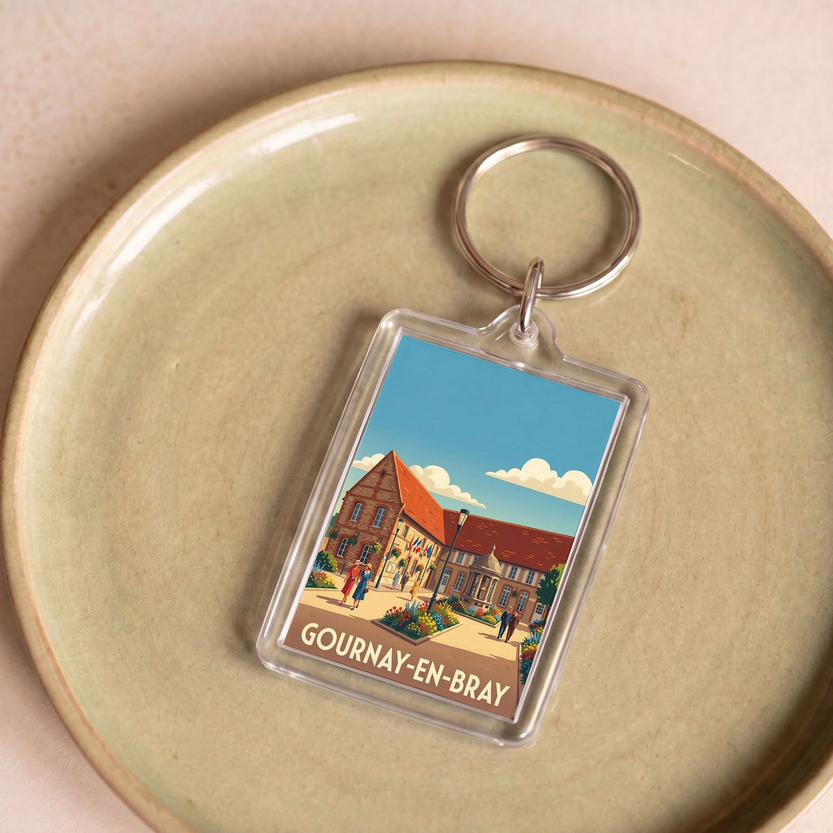 Porte-clés souvenir de la ville de Gournay-en-Bray avec une illustration stylisée.