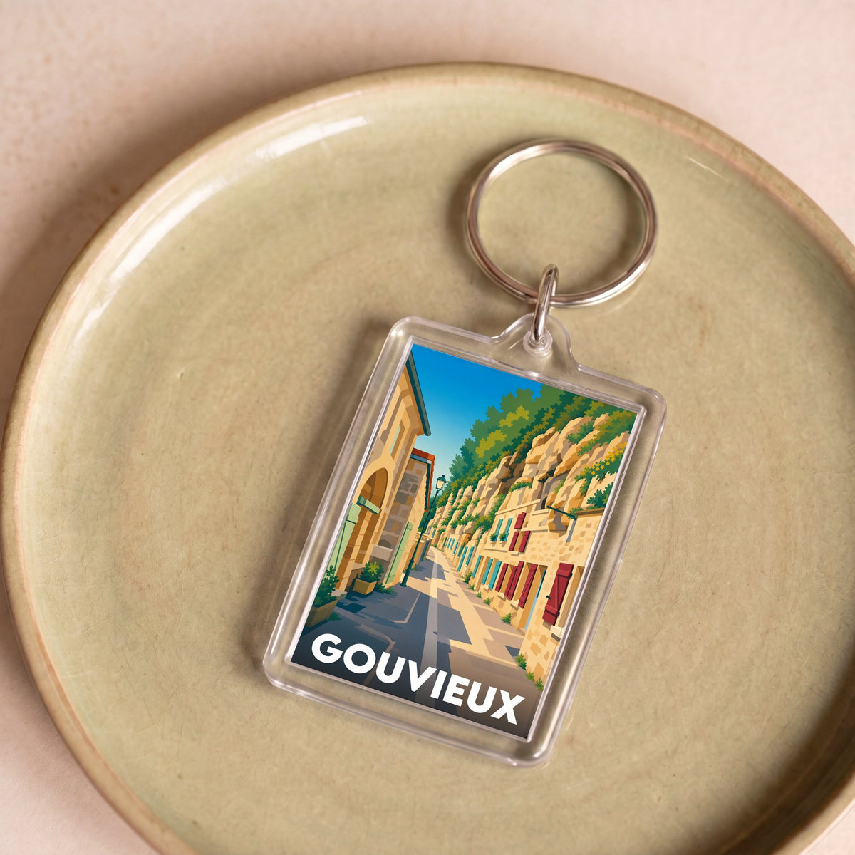 Porte-clés souvenir de la ville de Gouvieux avec une illustration stylisée.