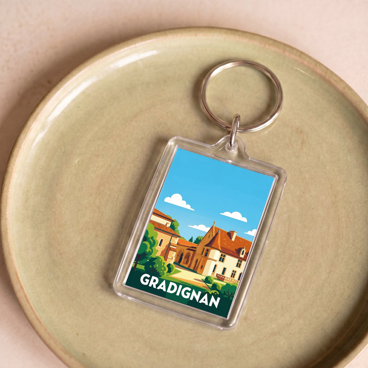 Porte-clés souvenir de la ville de Gradignan avec une illustration stylisée.