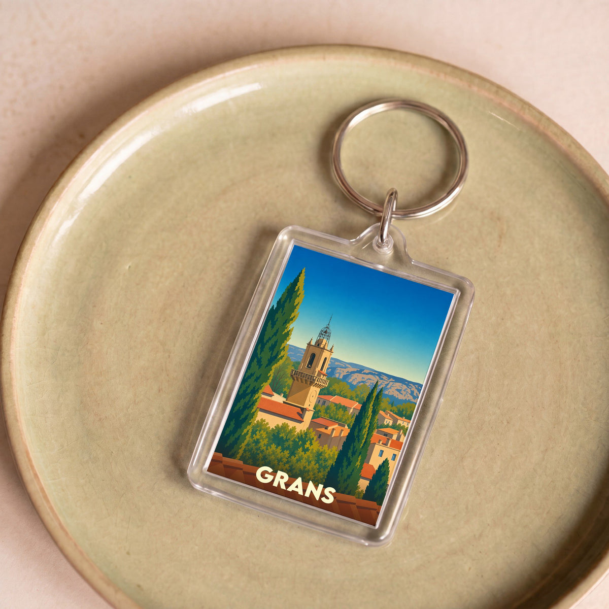 Porte-clés souvenir de la ville de Grans avec une illustration stylisée.