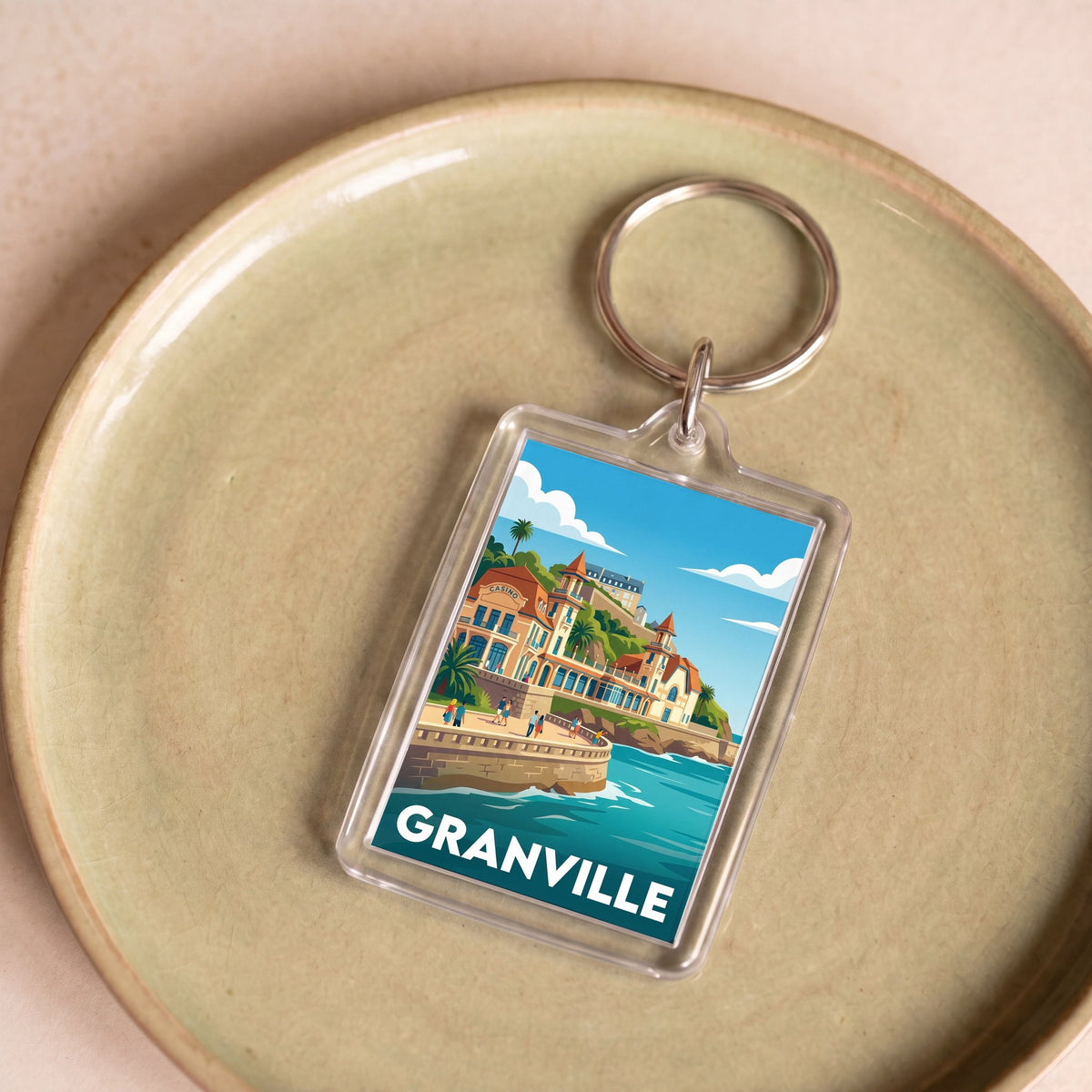Porte-clés souvenir de la ville de Granville avec une illustration stylisée.