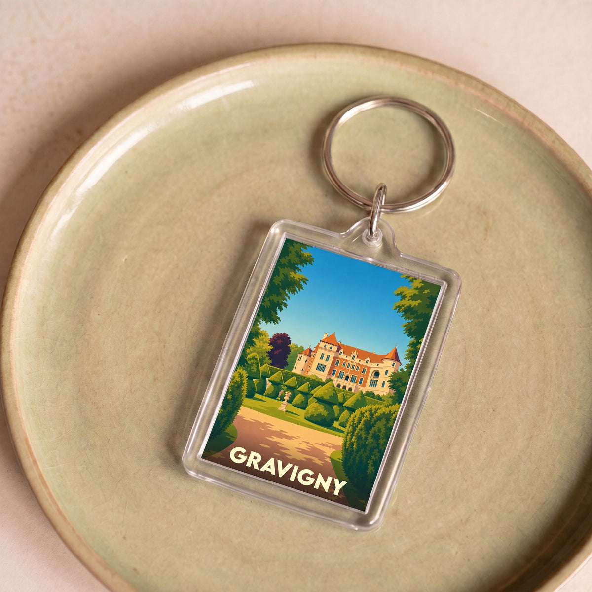 Porte-clés souvenir de la ville de Gravigny avec une illustration stylisée de son château.