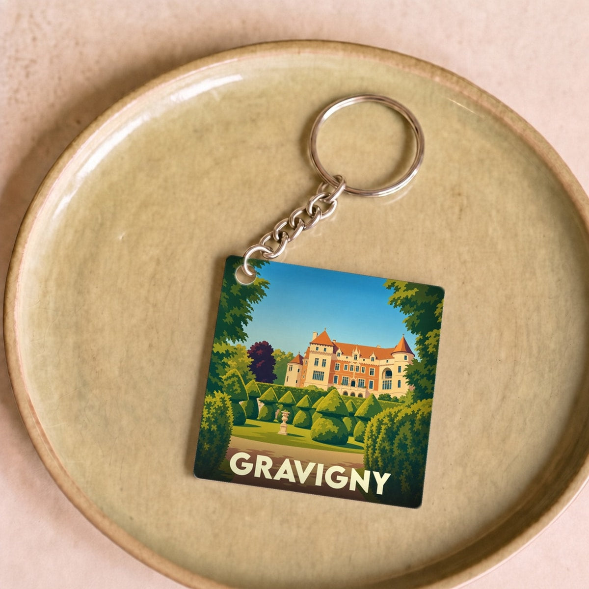 Porte-clés souvenir de la ville de Gravigny avec une illustration stylisée de son château.