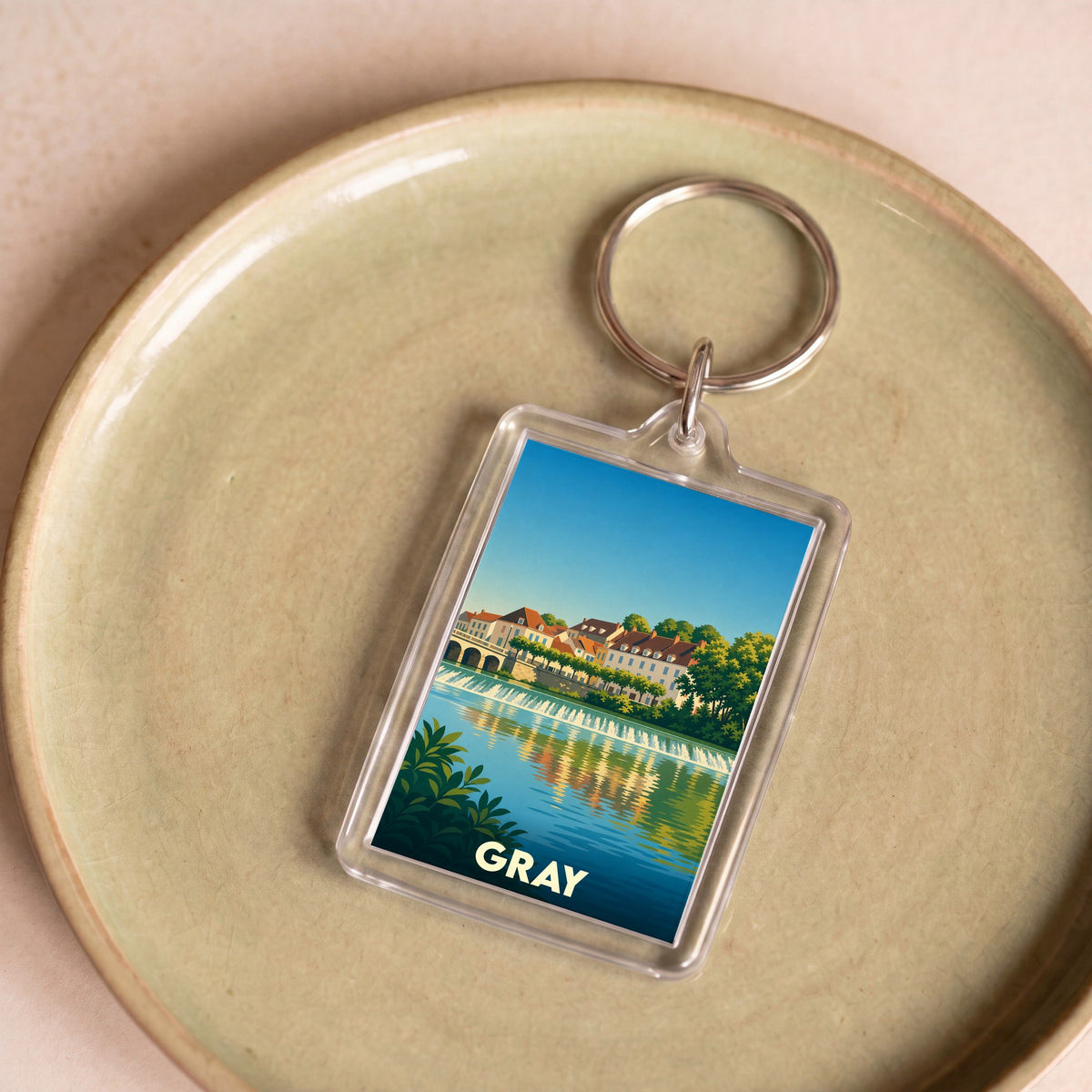 Porte-clés souvenir de la ville de Gray avec une illustration stylisée des bords de Saône.