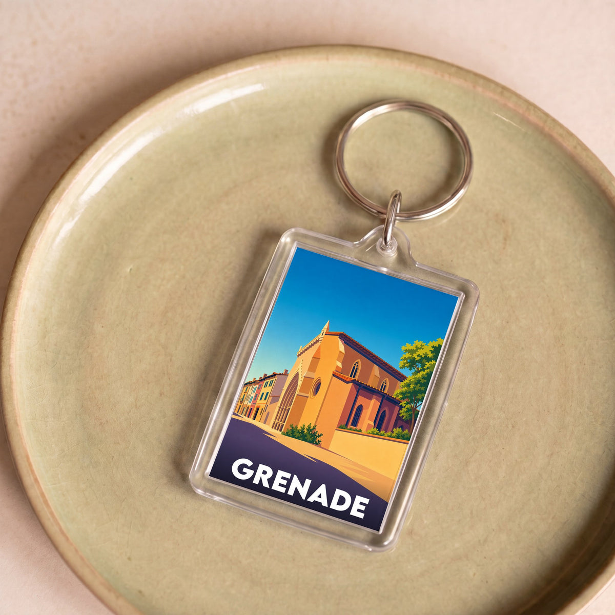 Porte-clés souvenir de la ville de Grenade avec une illustration stylisée d'un monument historique.