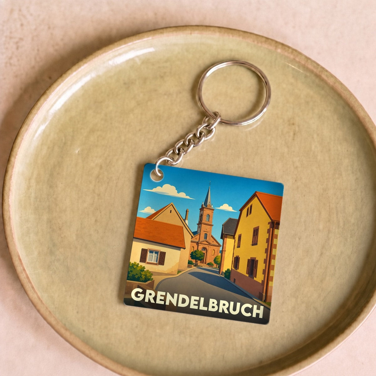Porte-clés souvenir de la ville de Grendelbruch avec une illustration stylisée.