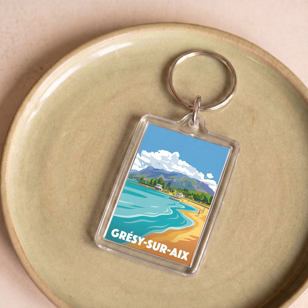 Porte-clés souvenir de la ville de Grésy-sur-Aix avec une illustration stylisée.