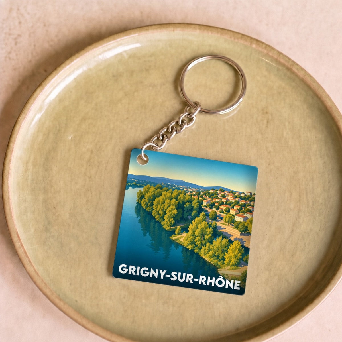 Porte-clés souvenir de la ville de Grigny-sur-Rhône avec une illustration stylisée.