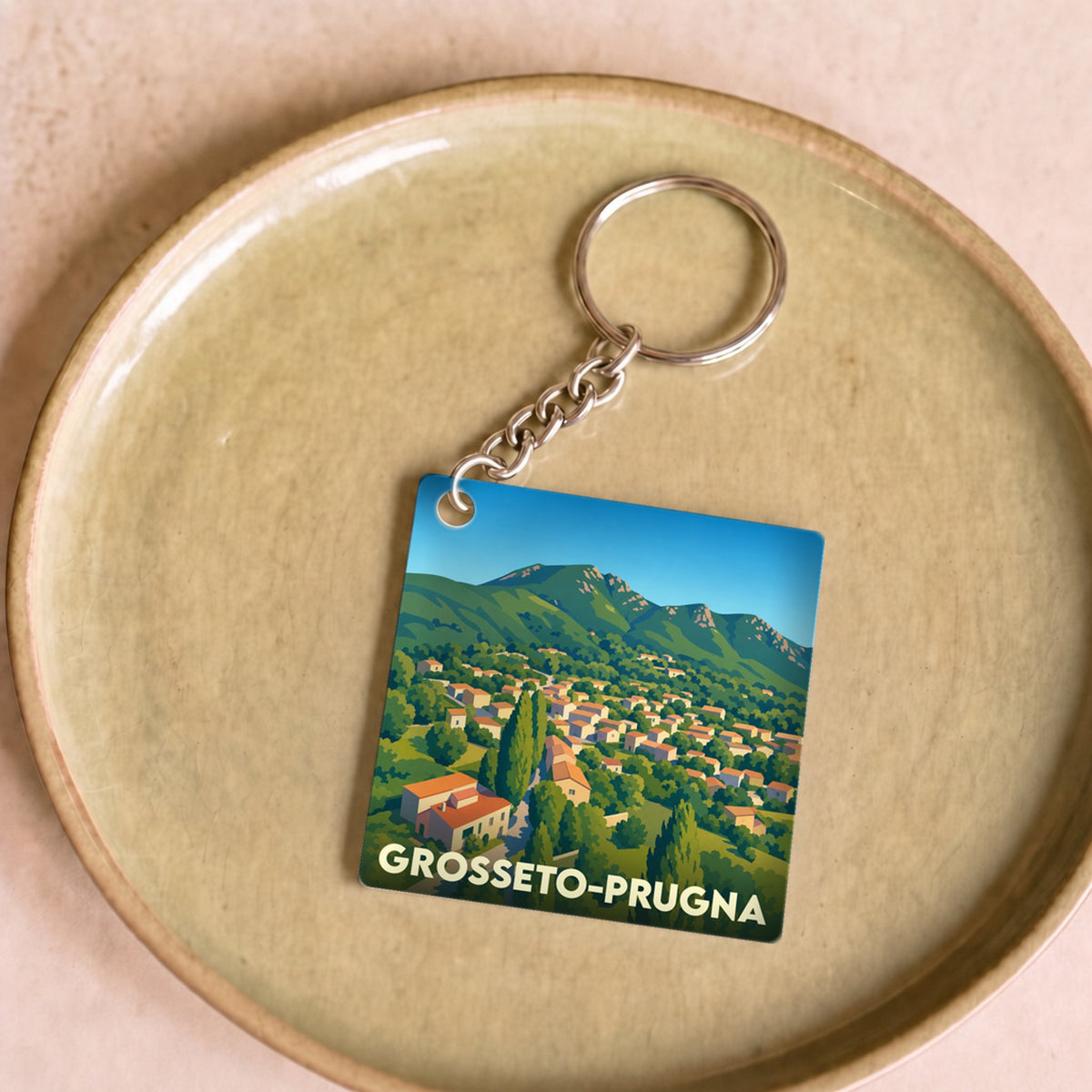 Porte-clés souvenir de la ville de Grosseto-Prugna avec une illustration stylisée.