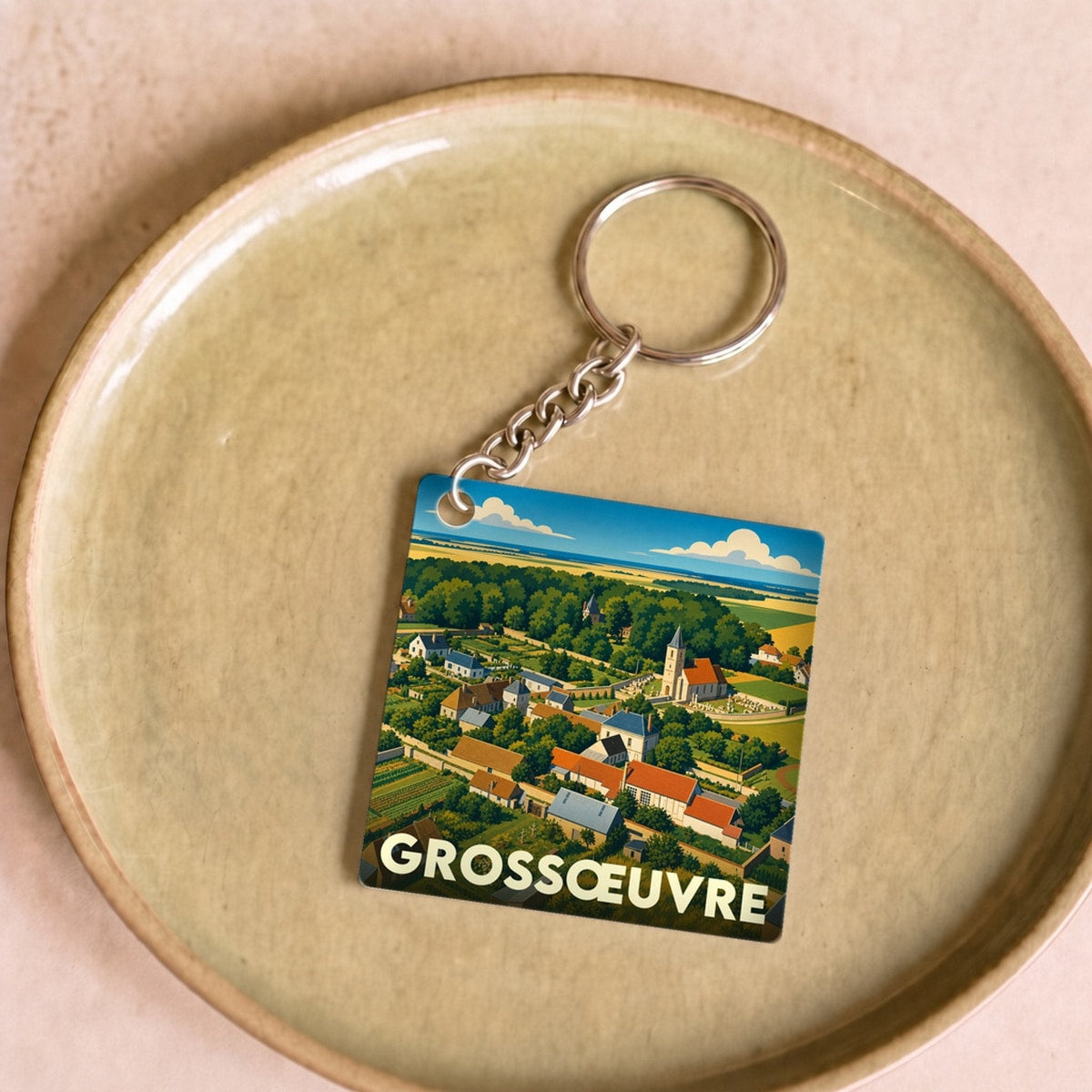 Porte-clés souvenir de la ville de Grossœuvre avec une illustration stylisée.
