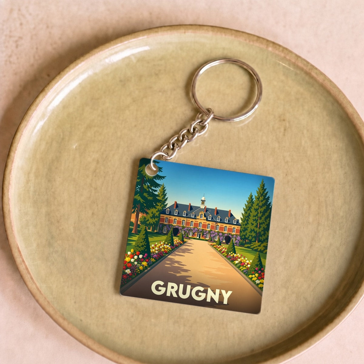 Porte-clés souvenir de la ville de Grugny avec une illustration stylisée.