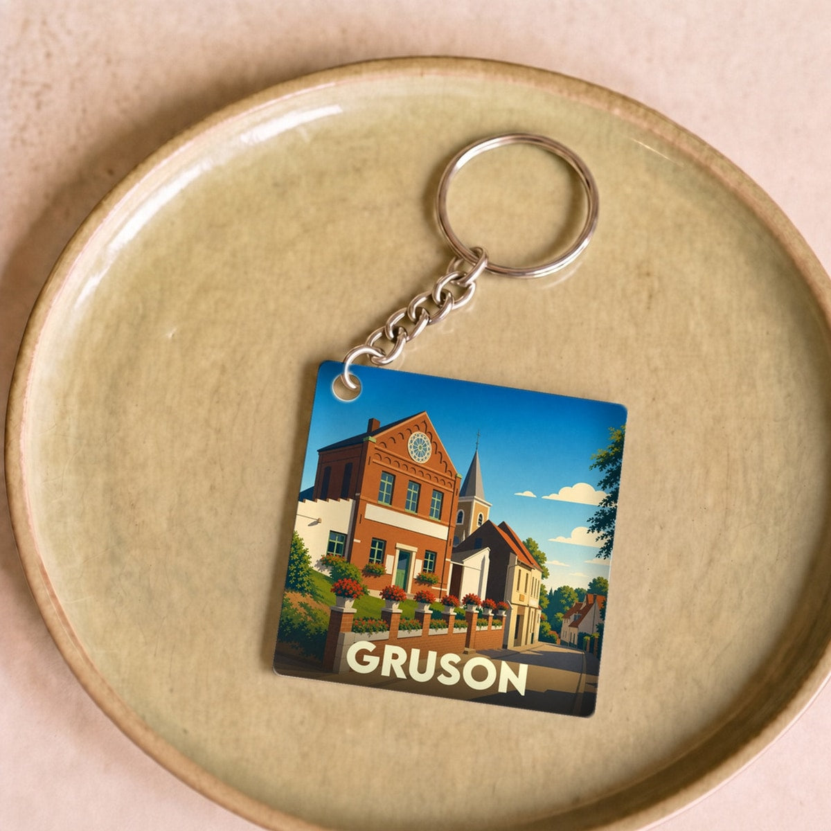Porte-clés souvenir de la ville de Gruson avec une illustration stylisée.