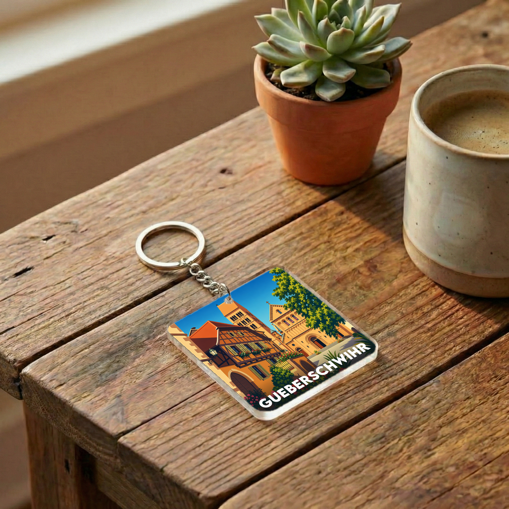 Porte-clés souvenir de la ville de Gueberschwihr avec une illustration stylisée.