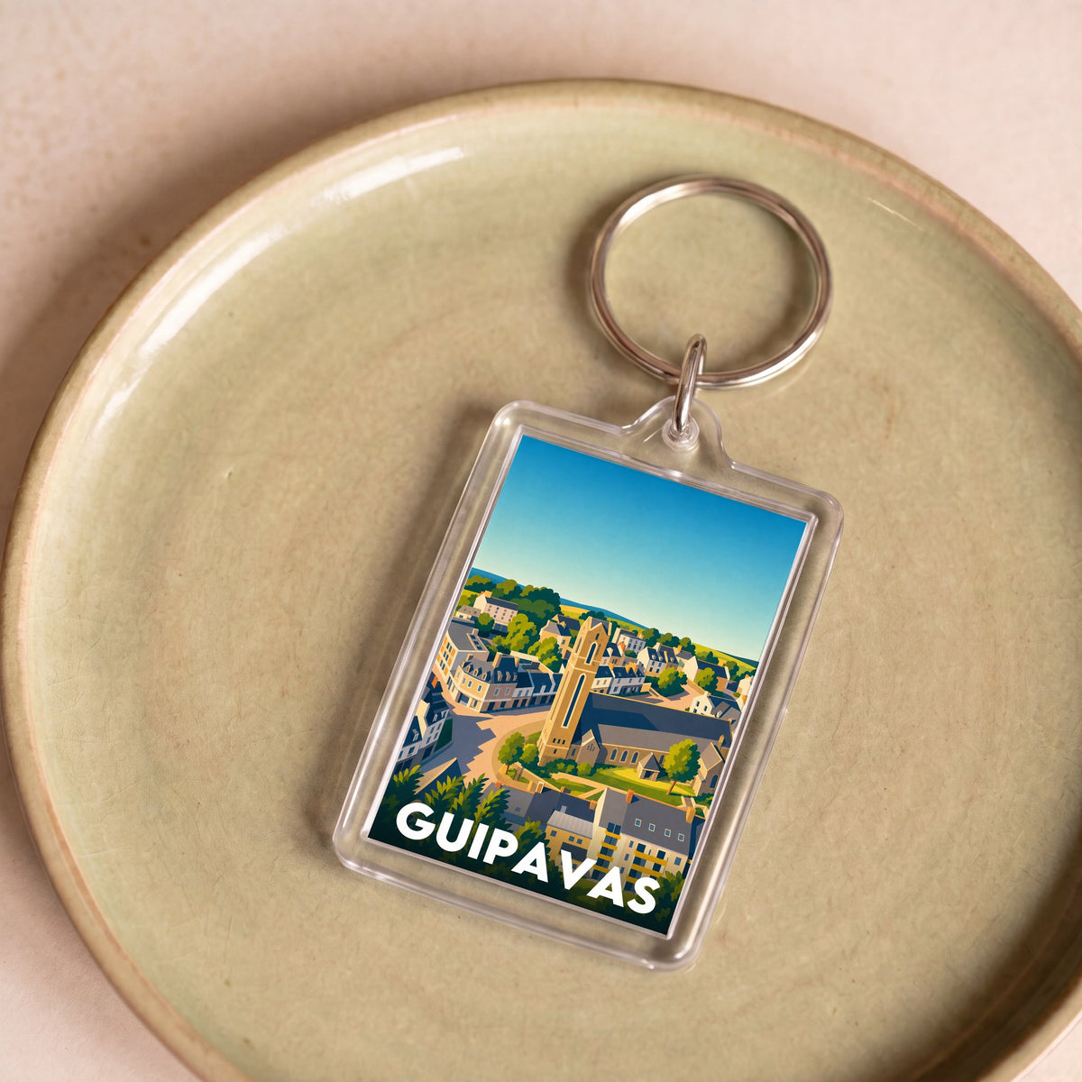 Porte-clés souvenir de la ville de Guipavas avec une illustration stylisée.