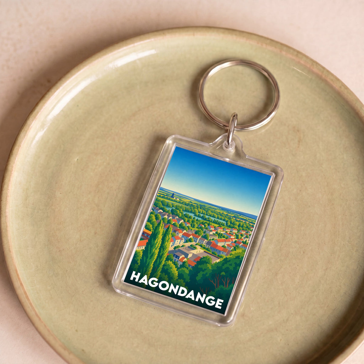 Porte-clés souvenir de la ville de Hagondange avec une illustration panoramique stylisée.