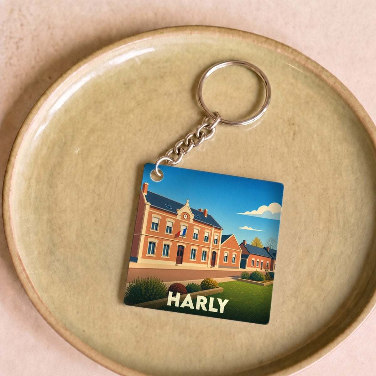 Porte-clés souvenir de la ville de Harly avec une illustration stylisée.