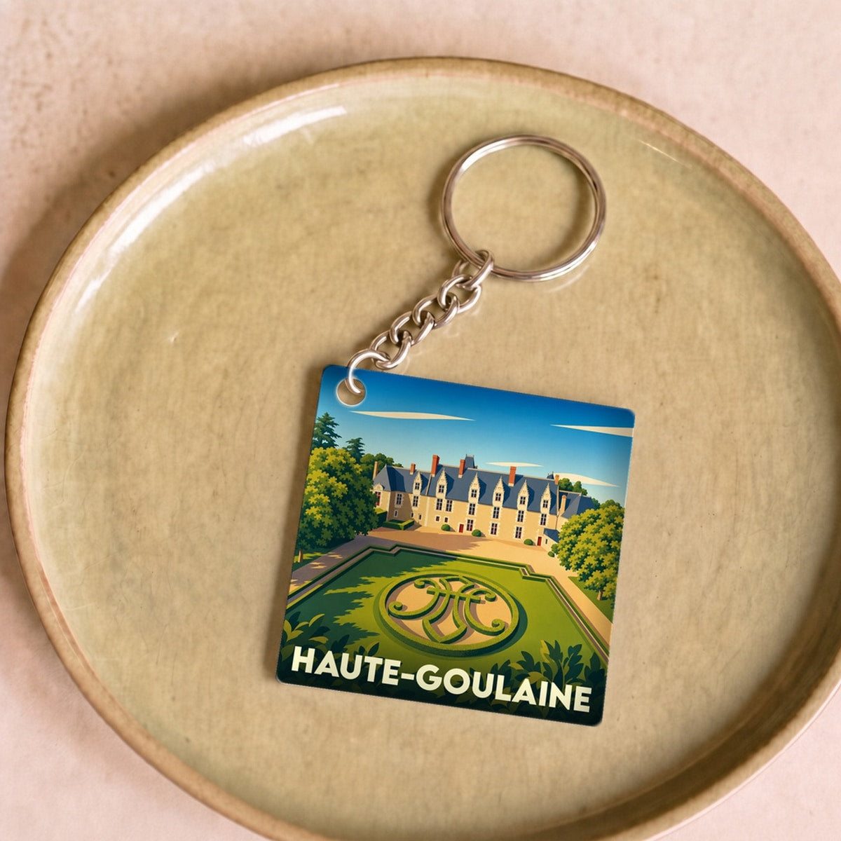 Porte-clés souvenir de la ville de Haute-Goulaine avec une illustration stylisée de son château.