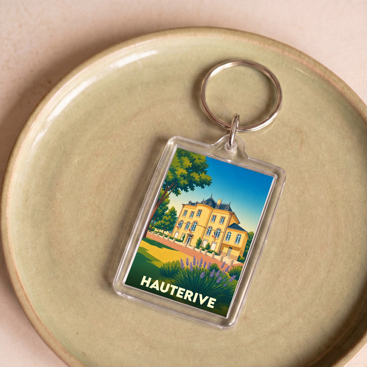Porte-clés souvenir de la ville de Hauterive avec une illustration stylisée.