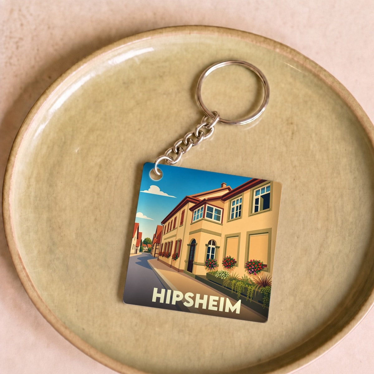 Porte-clés souvenir de la ville de Hipsheim avec une illustration stylisée.
