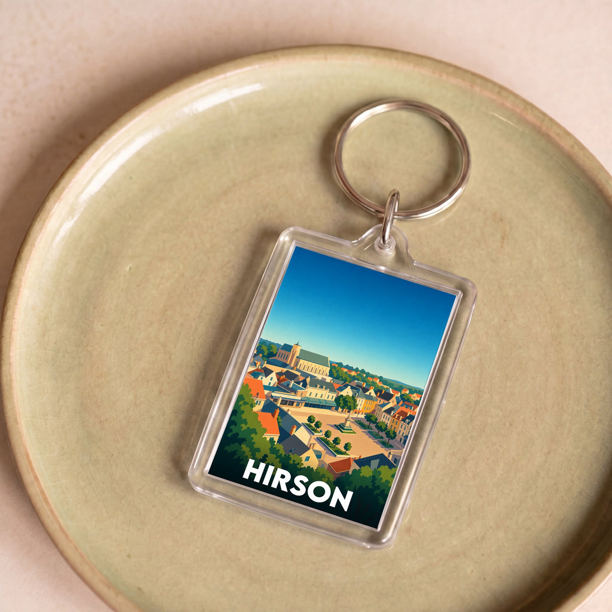 Porte-clés souvenir de la ville de Hirson avec une illustration panoramique colorée.
