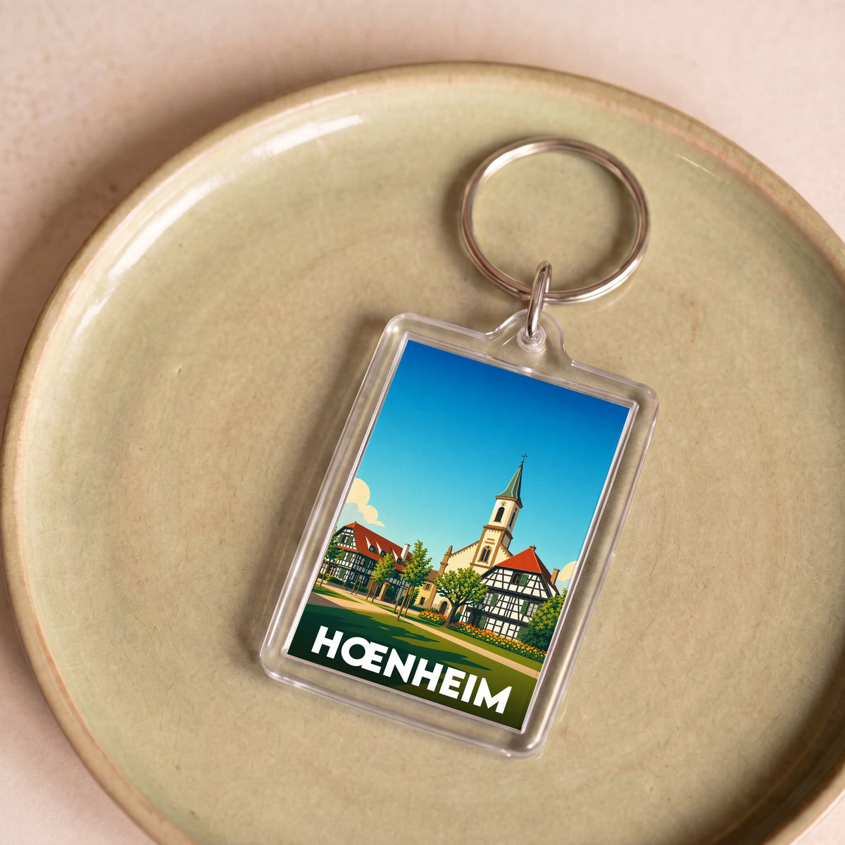 Porte-clés souvenir de la ville de Hœnheim avec une illustration stylisée.