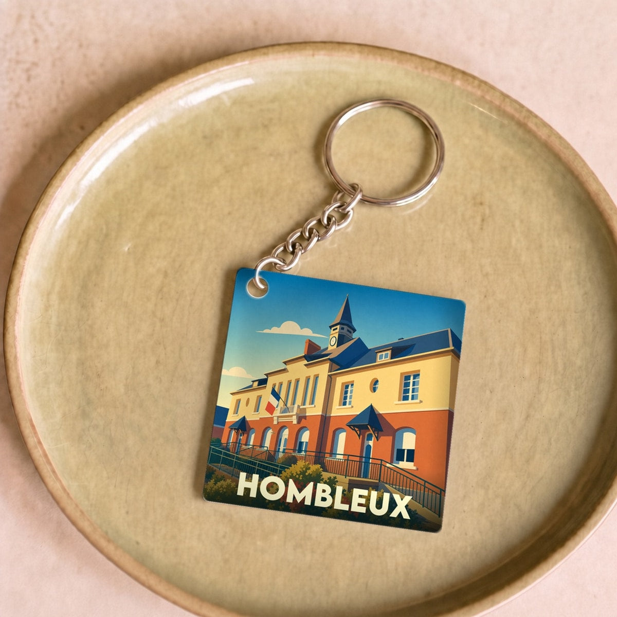 Porte-clés souvenir de la ville de Hombleux avec une illustration stylisée de sa mairie.