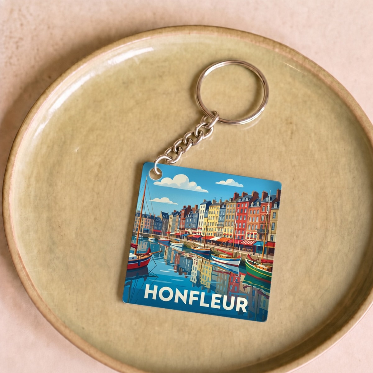 Porte-clés souvenir de la ville de Honfleur avec une illustration stylisée et colorée de son port.