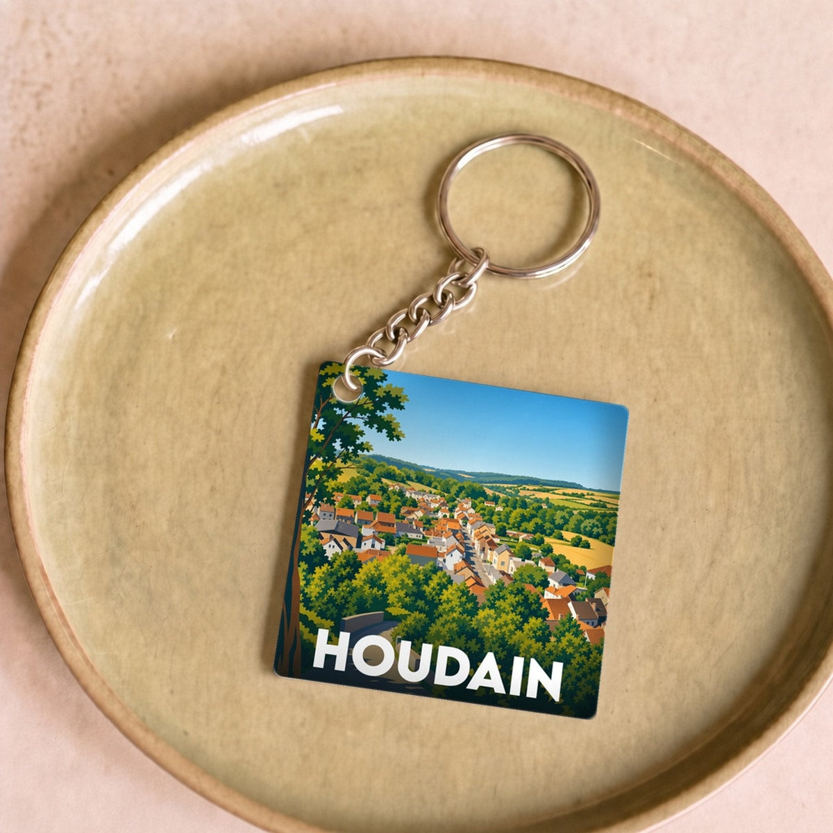 Porte-clés souvenir de la ville de Houdain avec une illustration stylisée.