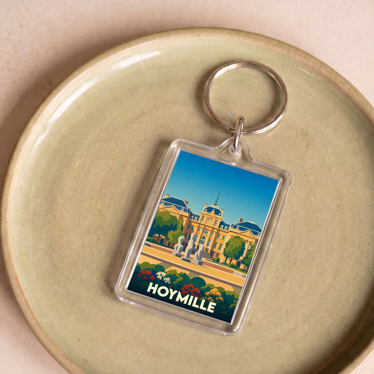 Porte-clés souvenir de la ville de Hoymille avec une illustration stylisée.