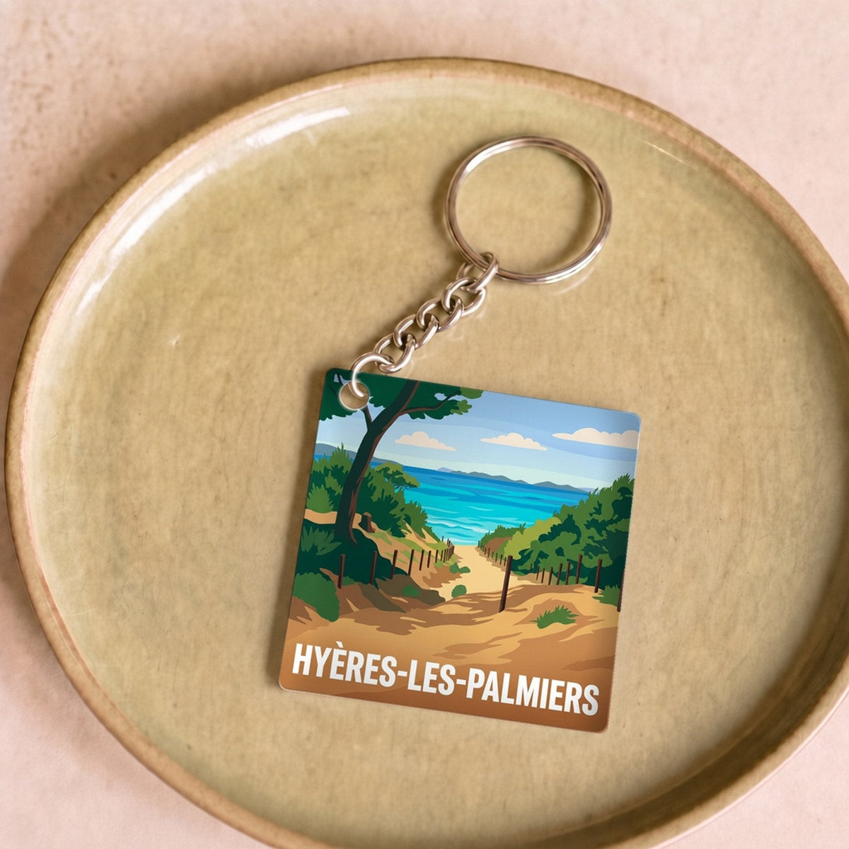Porte-clés souvenir de la ville de Hyères-les-Palmiers avec une illustration stylisée.