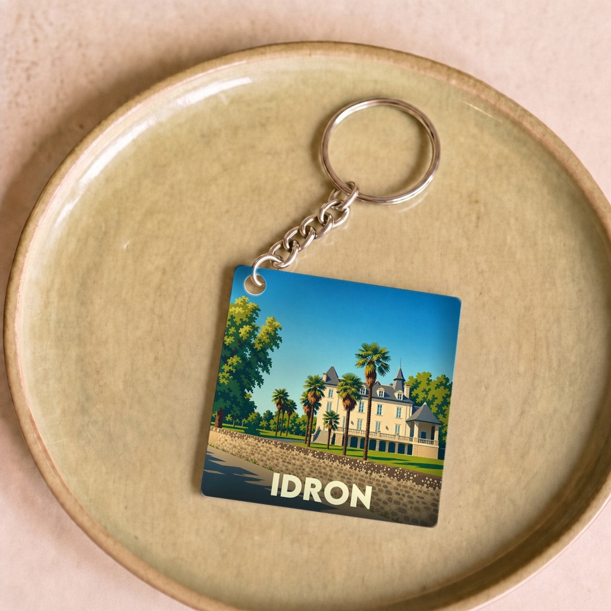 Porte-clés souvenir de la ville d'Idron avec une illustration stylisée de son château.