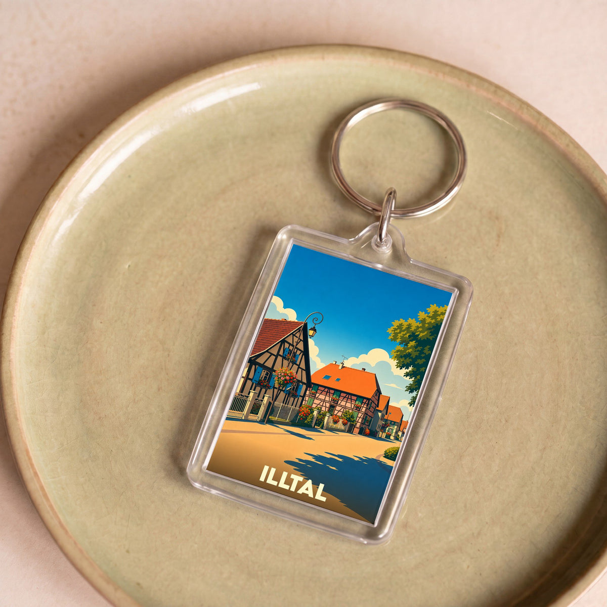 Porte-clés souvenir de la ville de Illtal avec une illustration stylisée de maisons à colombages.