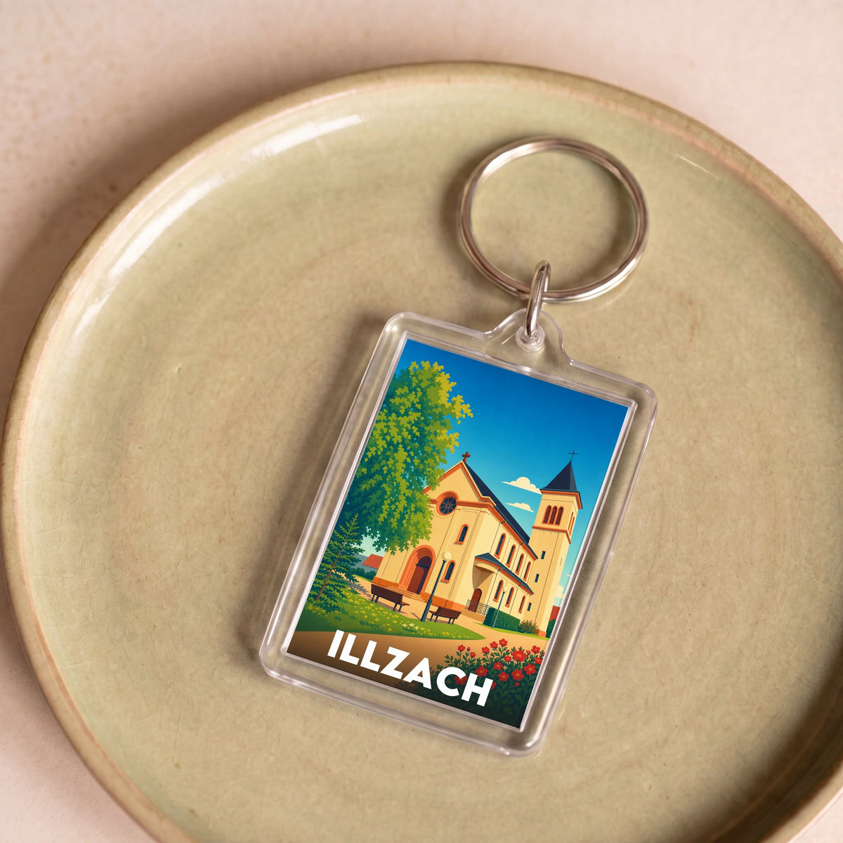 Porte-clés souvenir de la ville d'Illzach avec une illustration stylisée d'une église locale.