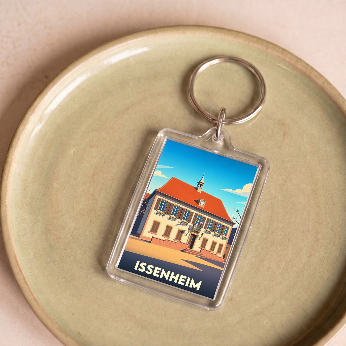 Porte-clés souvenir de la ville d'Issenheim avec une illustration stylisée de sa mairie.