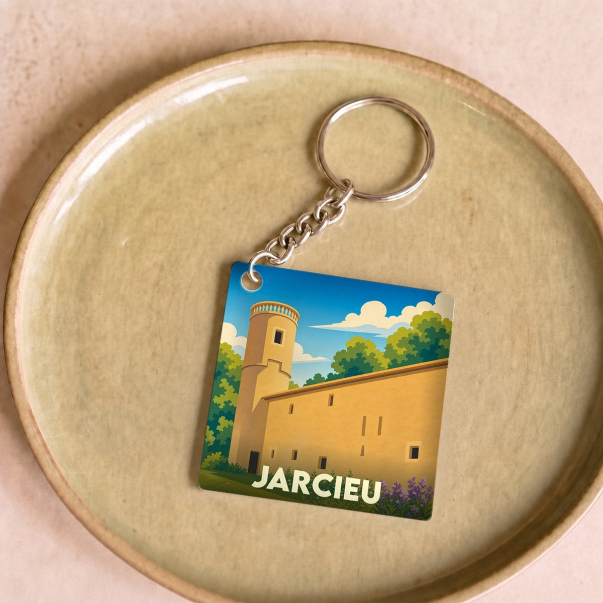 Porte-clés souvenir de la ville de Jarcieu avec une illustration stylisée de son patrimoine.