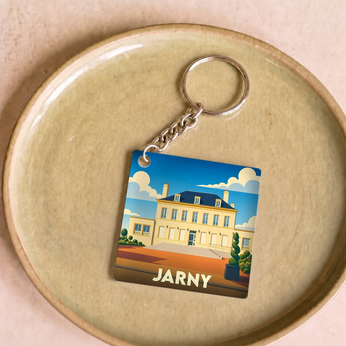 Porte-clés souvenir de la ville de Jarny avec une illustration stylisée.
