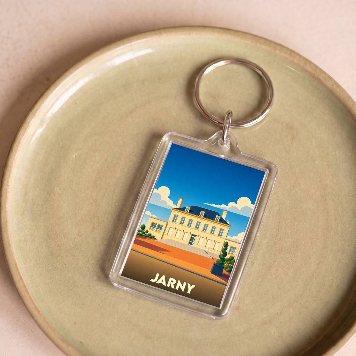 Porte-clés souvenir de la ville de Jarny avec une illustration stylisée.