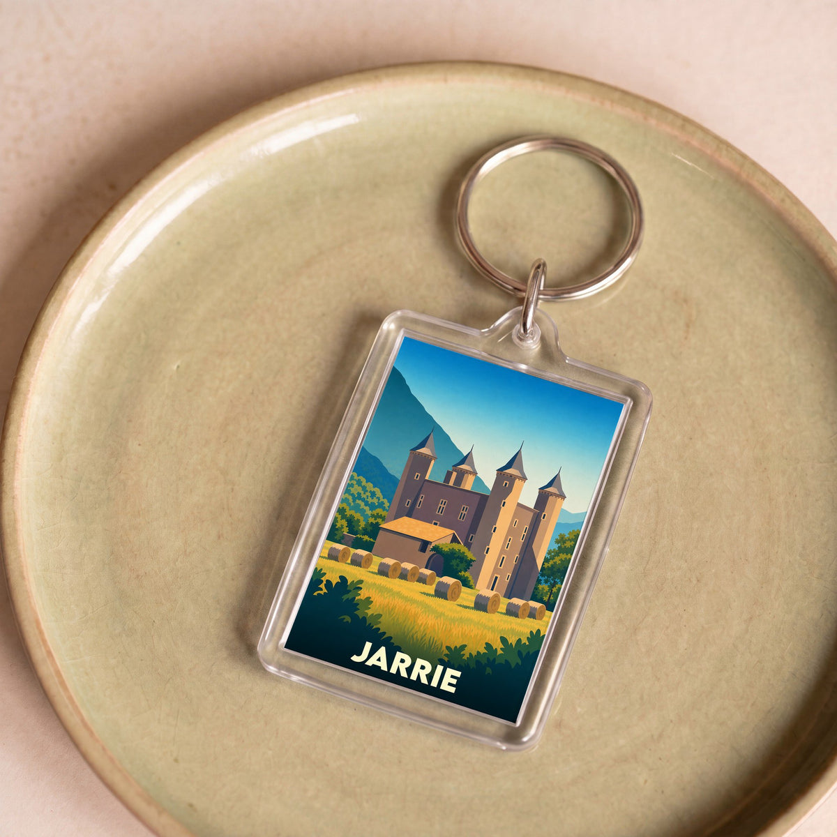 Porte-clés souvenir de la ville de Jarrie avec une illustration stylisée de son château.