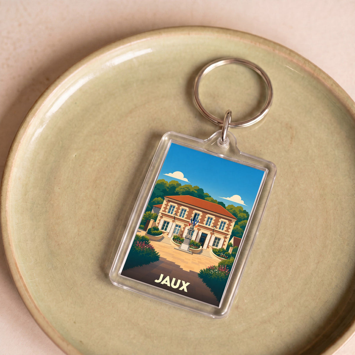 Porte-clés souvenir de la ville de Jaux avec une illustration stylisée de sa mairie.