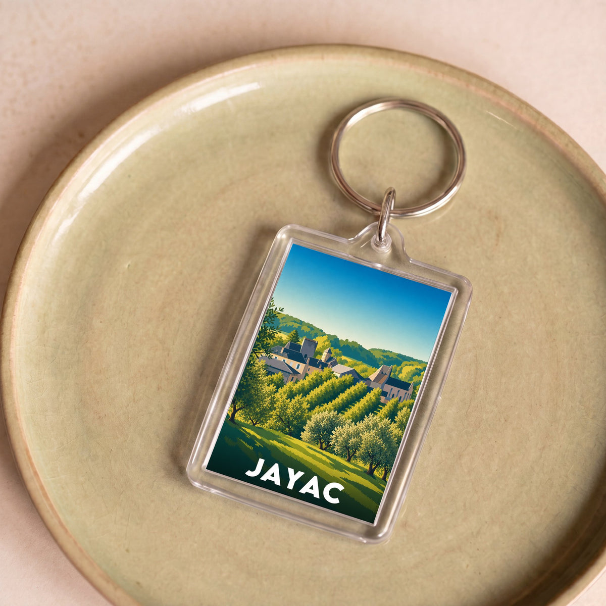 Porte-clés souvenir de la ville de Jayac avec une illustration stylisée.