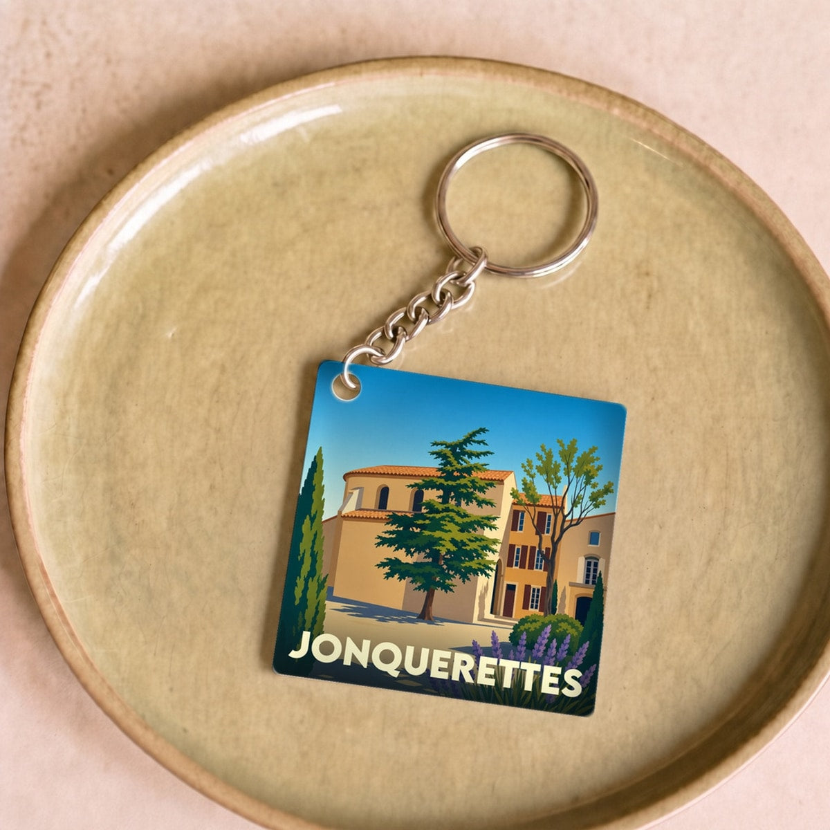 Porte-clés souvenir de la ville de Jonquerettes avec une illustration stylisée.