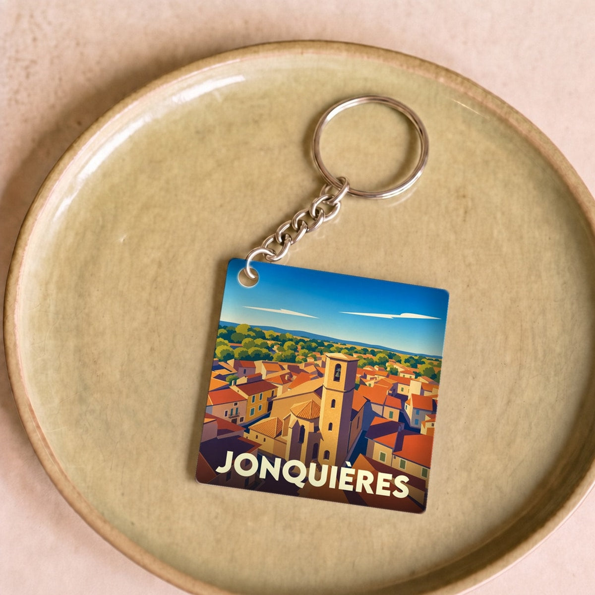 Porte-clés souvenir de la ville de Jonquières avec une illustration stylisée.