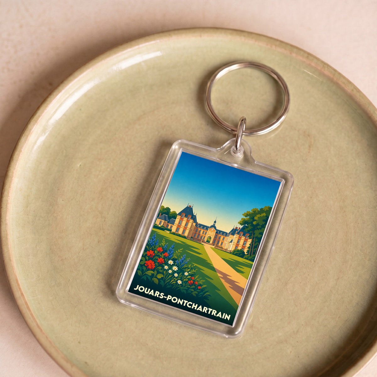 Porte-clés souvenir de la ville de Jouars-Pontchartrain avec une illustration stylisée de son château.