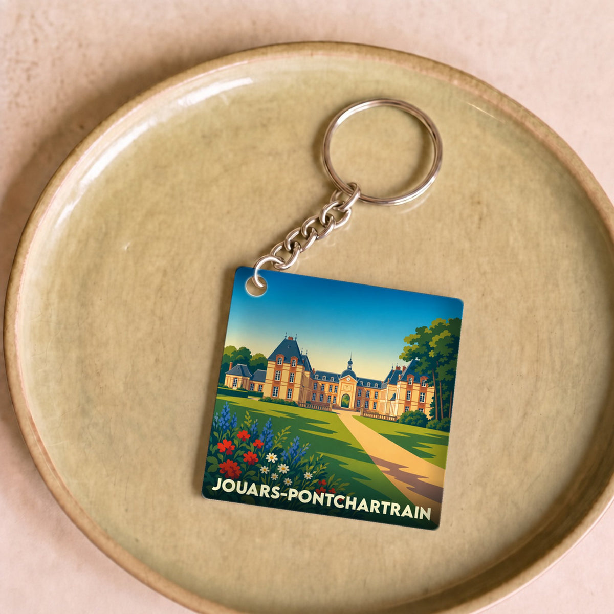 Porte-clés souvenir de la ville de Jouars-Pontchartrain avec une illustration stylisée de son château.