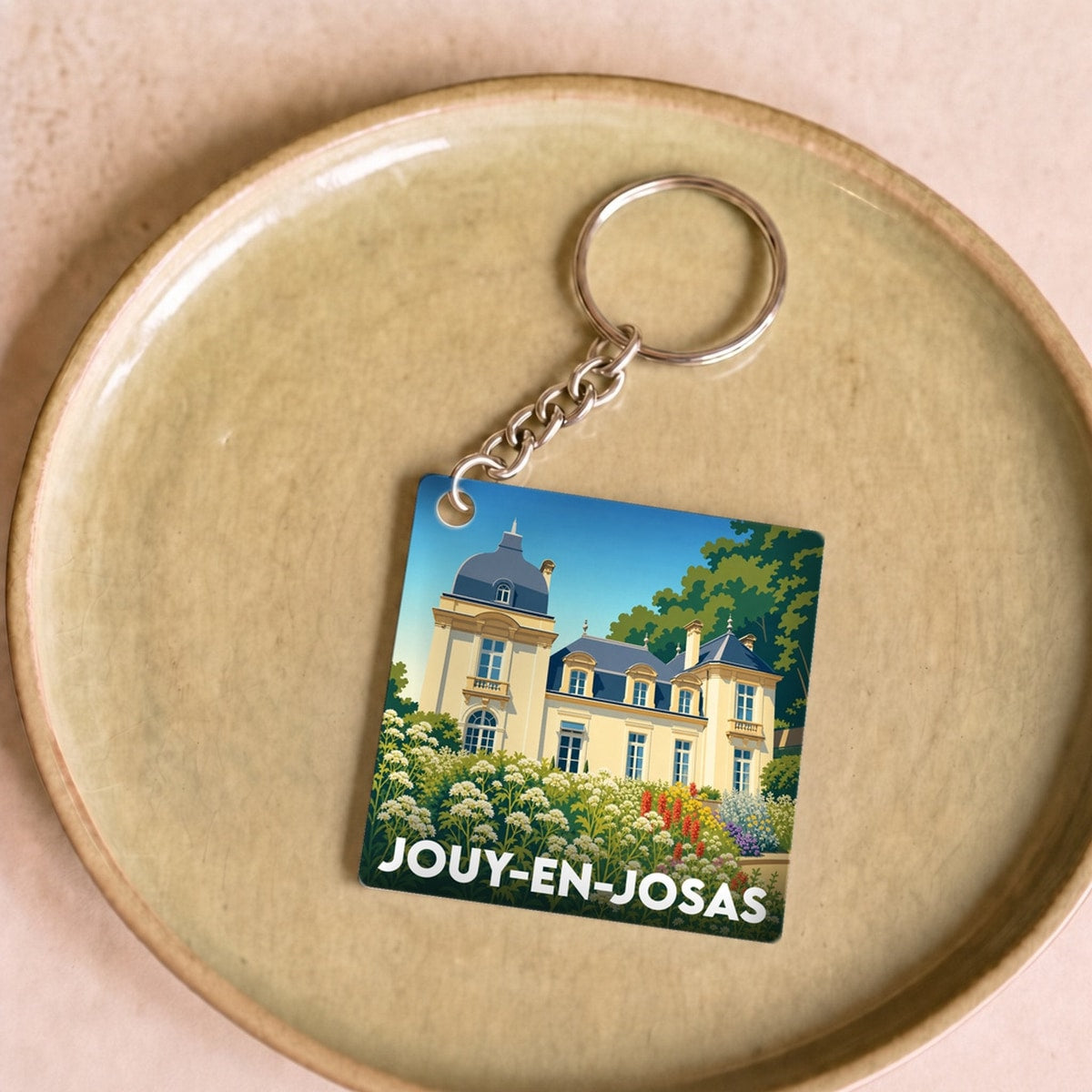 Porte-clés souvenir de la ville de Jouy-en-Josas avec une illustration stylisée de son patrimoine.