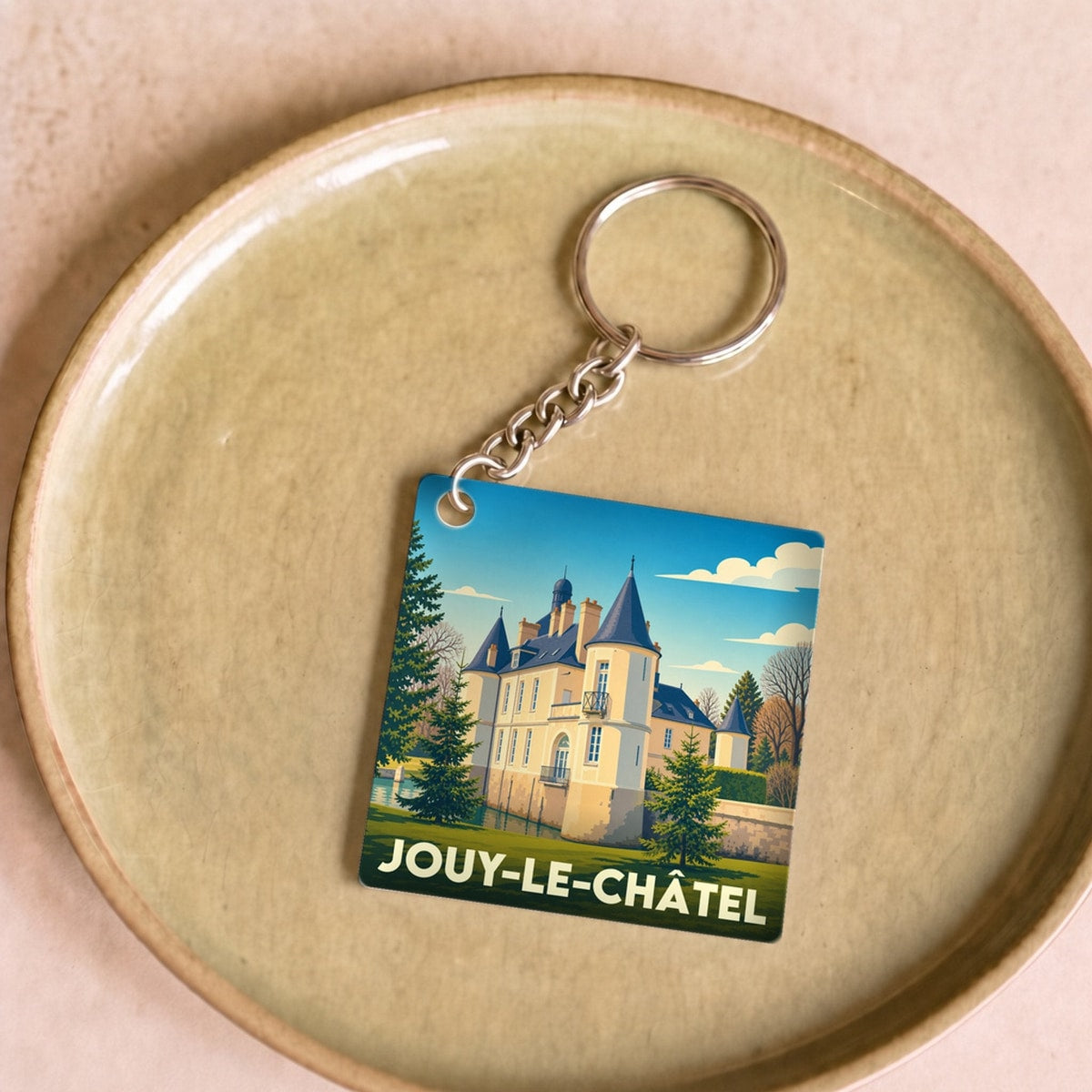 Porte-clés souvenir de la ville de Jouy-le-Châtel avec une illustration stylisée de son château.
