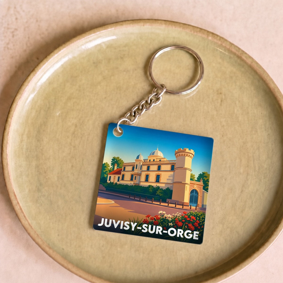 Porte-clés souvenir de la ville de Juvisy-sur-Orge avec une illustration stylisée.