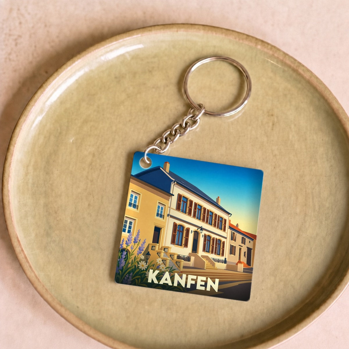Porte-clés souvenir de la ville de Kanfen avec une illustration stylisée.